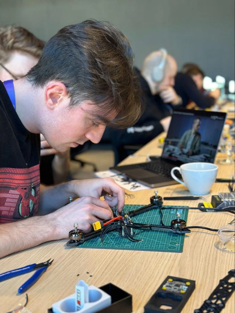 Hostinger's drone workshop participant assembling his drone