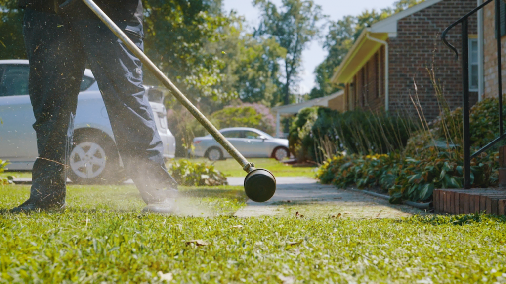 Jarrott using a power trimmer. 